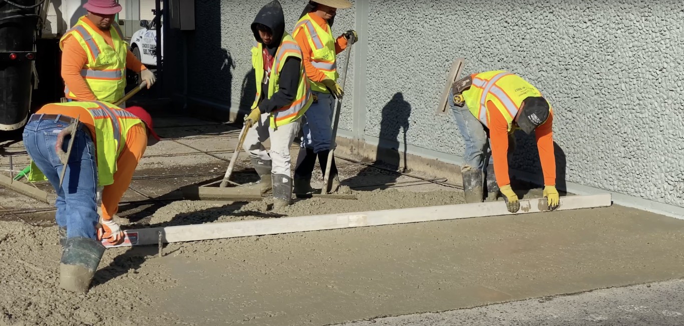 Concrete finishing crew working on sidewalk in St. Cloud, MN